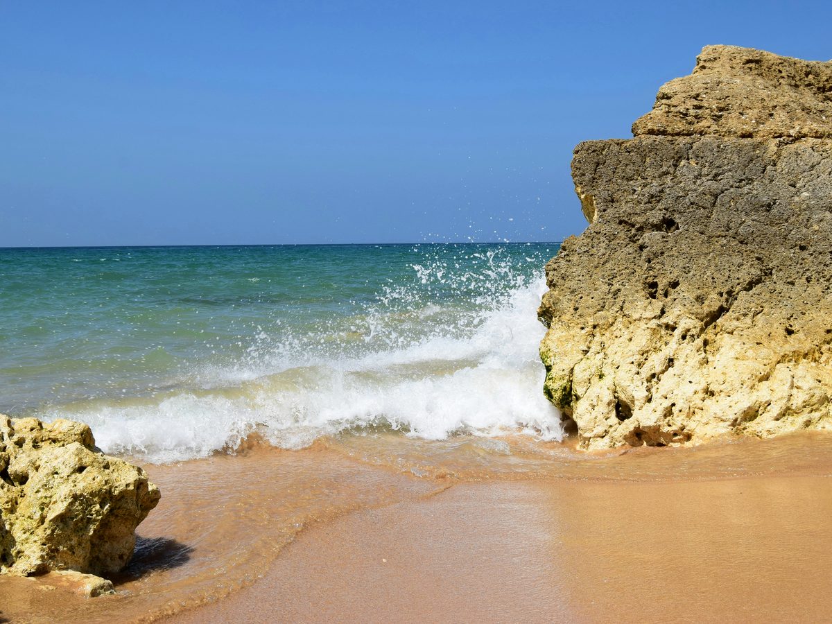 Golden sand and sandstone rock on the central coast