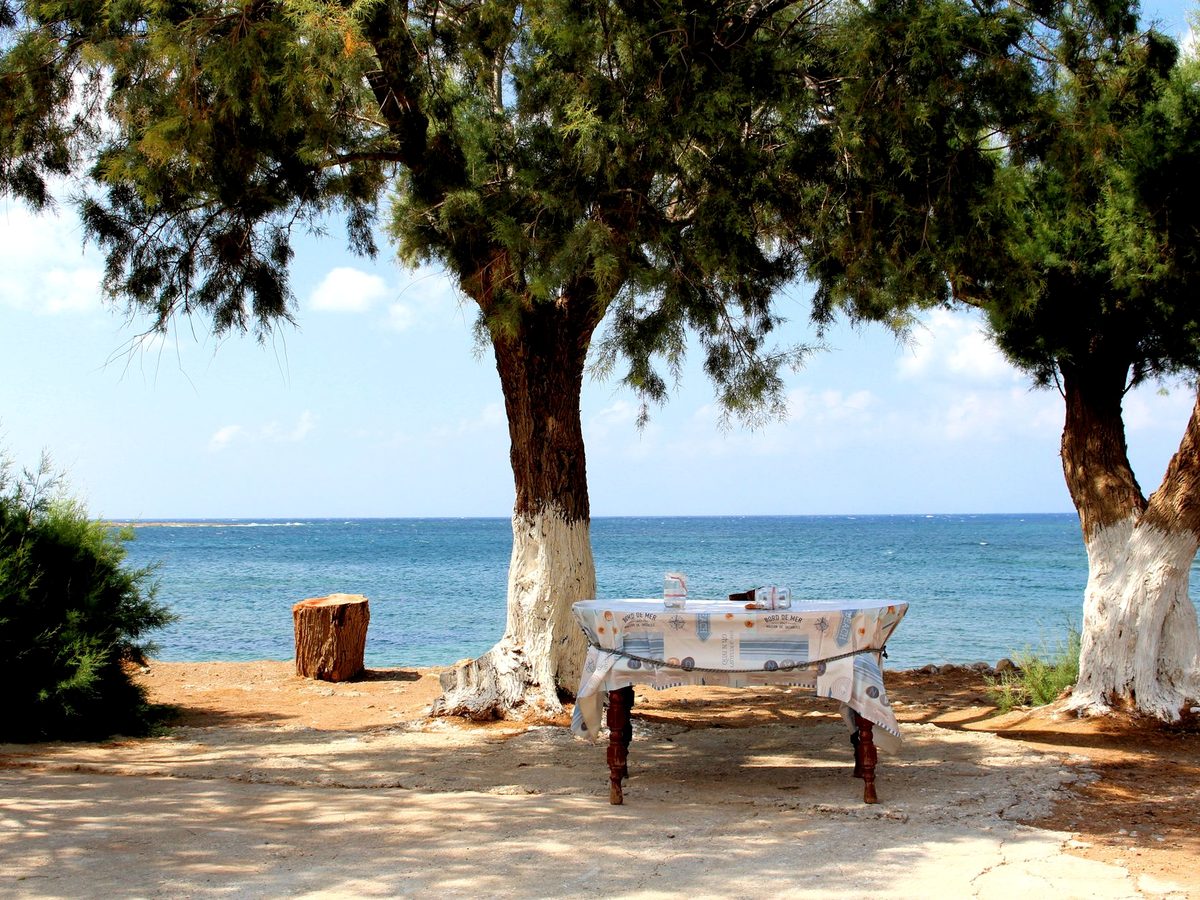A taverna table in the shade by the sea