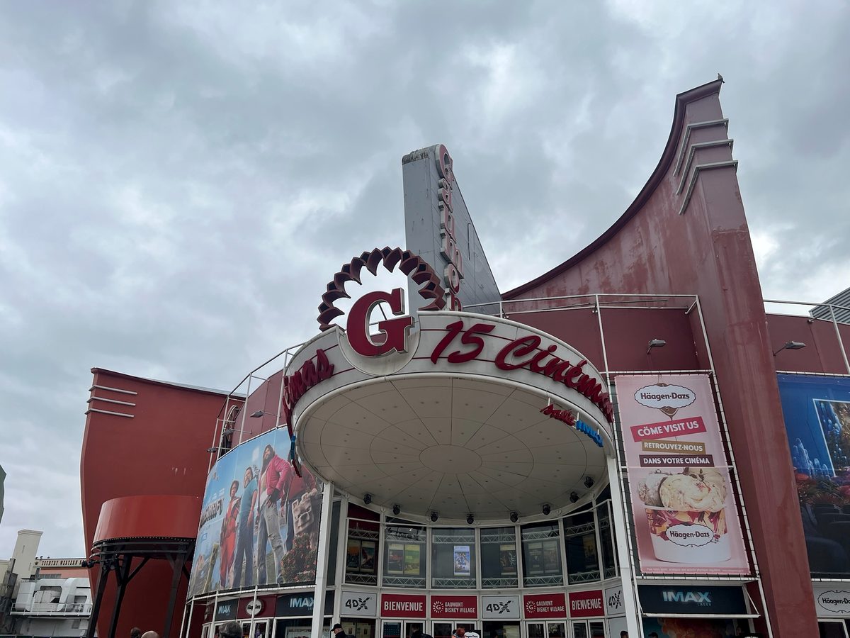 The red curved facade of the Gaumont Disney Village multiplex cinema, with its IMAX and 4DX signage and a rounded canopy over the entrance