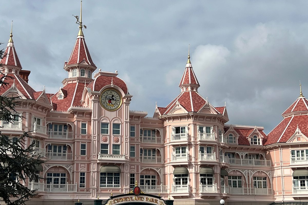 The central block of the Disneyland Hotel, its Mickey Mouse clock tower rising above the Disneyland Park entrance sign