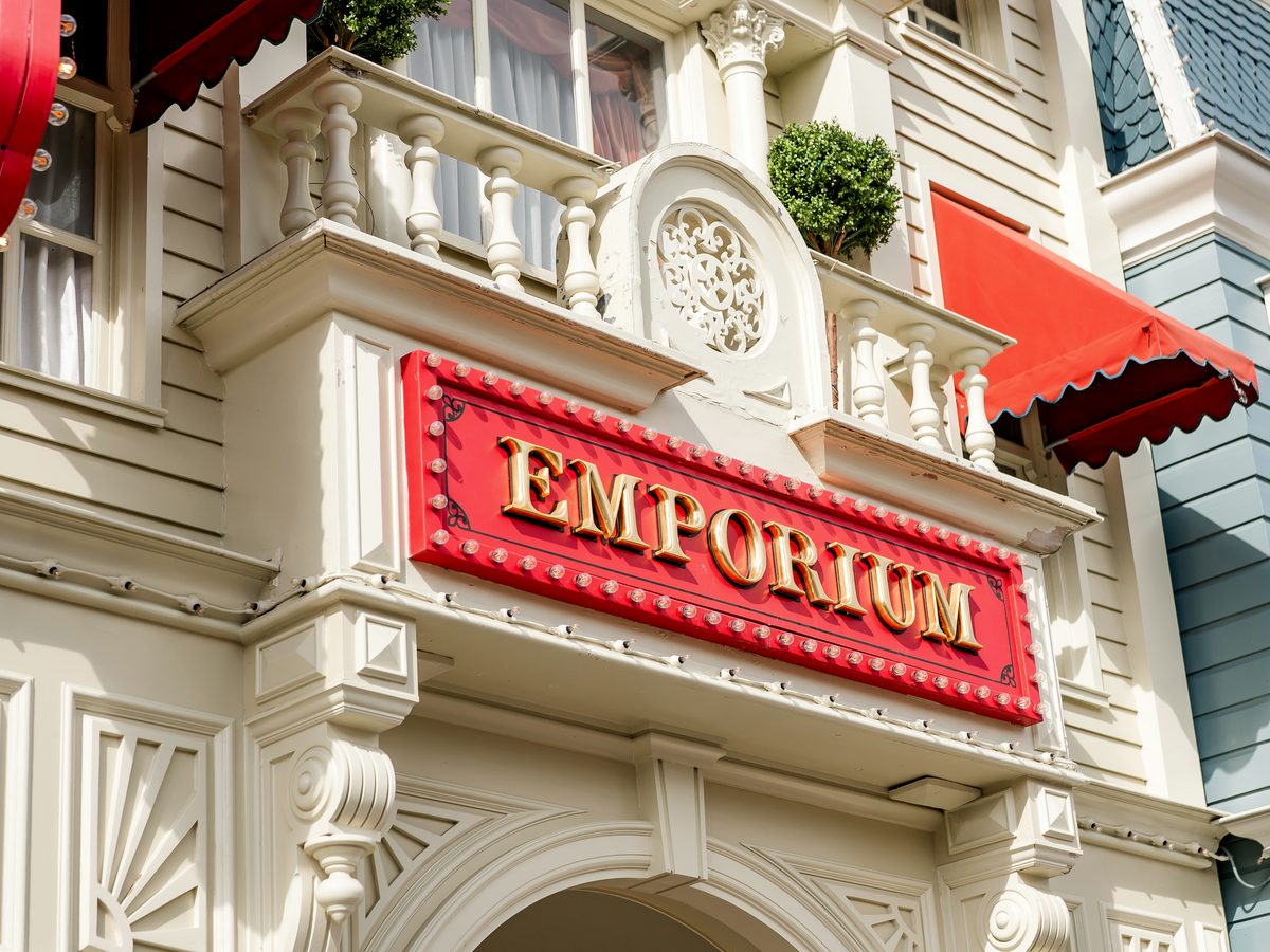 The red Emporium sign over the corner entrance of the shop on Main Street, U.S.A.