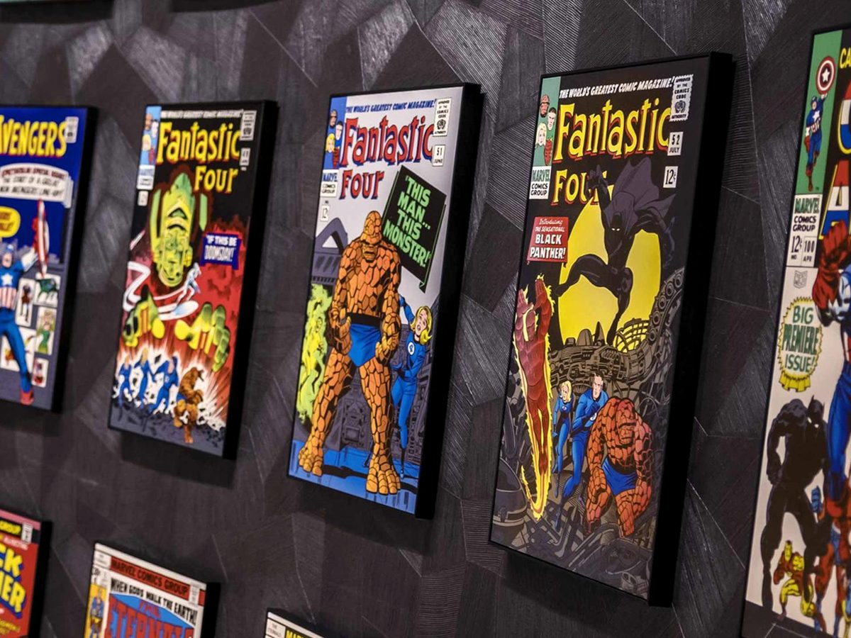 A wall of framed vintage Marvel comic covers including Avengers, Fantastic Four and Captain America