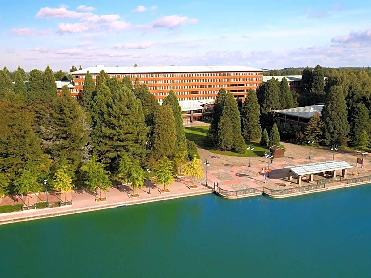The main lodge at Disney Sequoia Lodge from the air, set behind the redwoods along the Lake Disney promenade