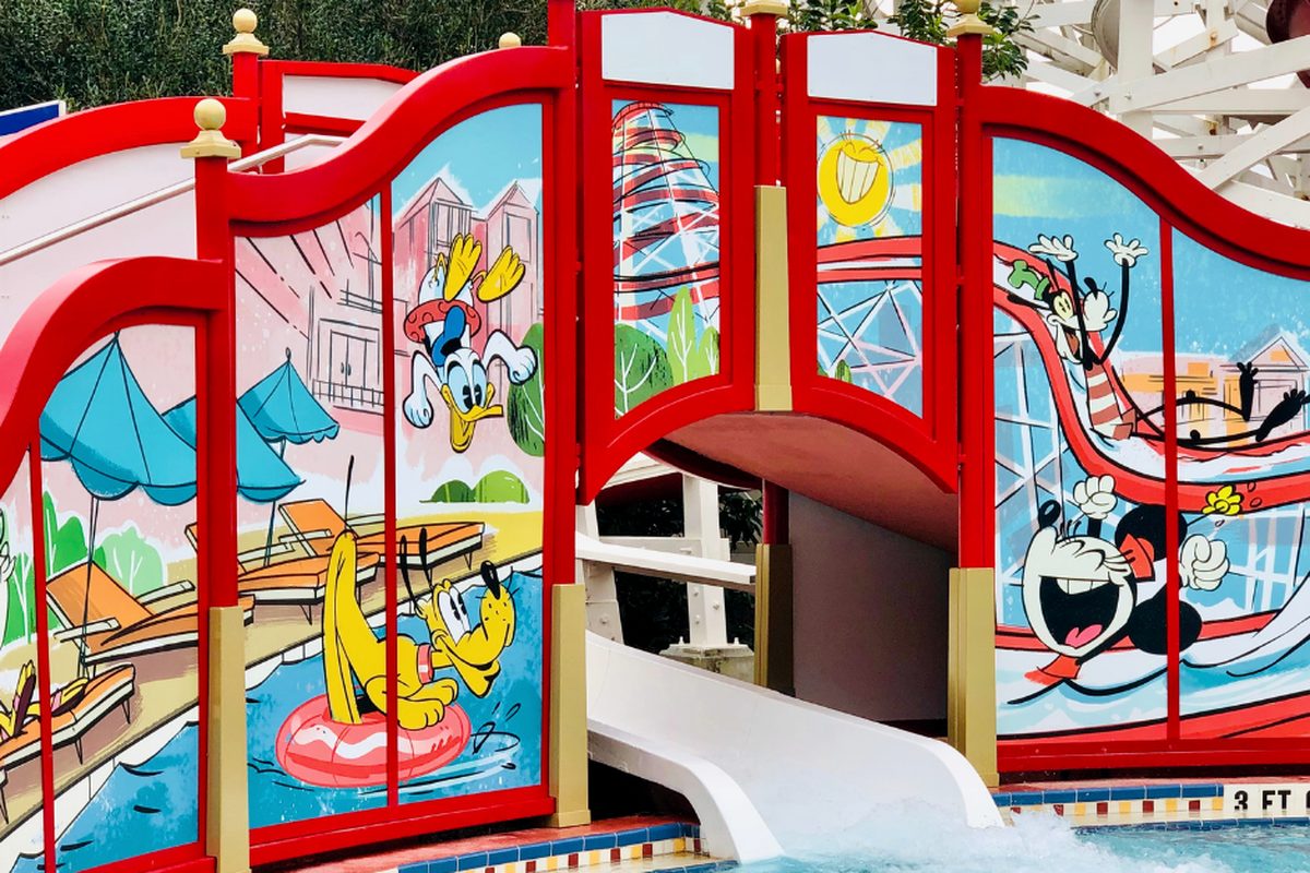 The Luna Park pool at Disney's BoardWalk Inn, with the red Keister Coaster water slide and cartoon murals