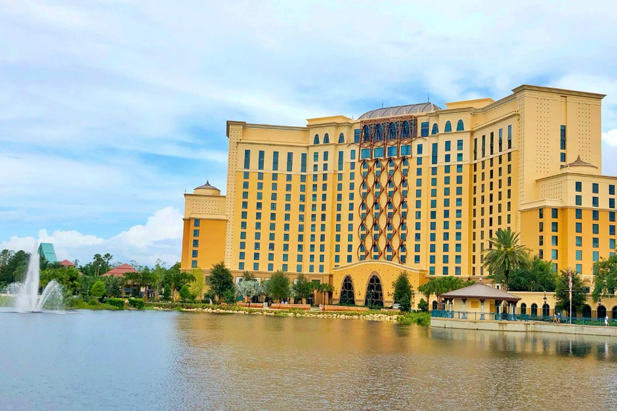 The 16-storey Gran Destino Tower at Disney's Coronado Springs Resort seen across Lago Dorado, with a fountain in the lake