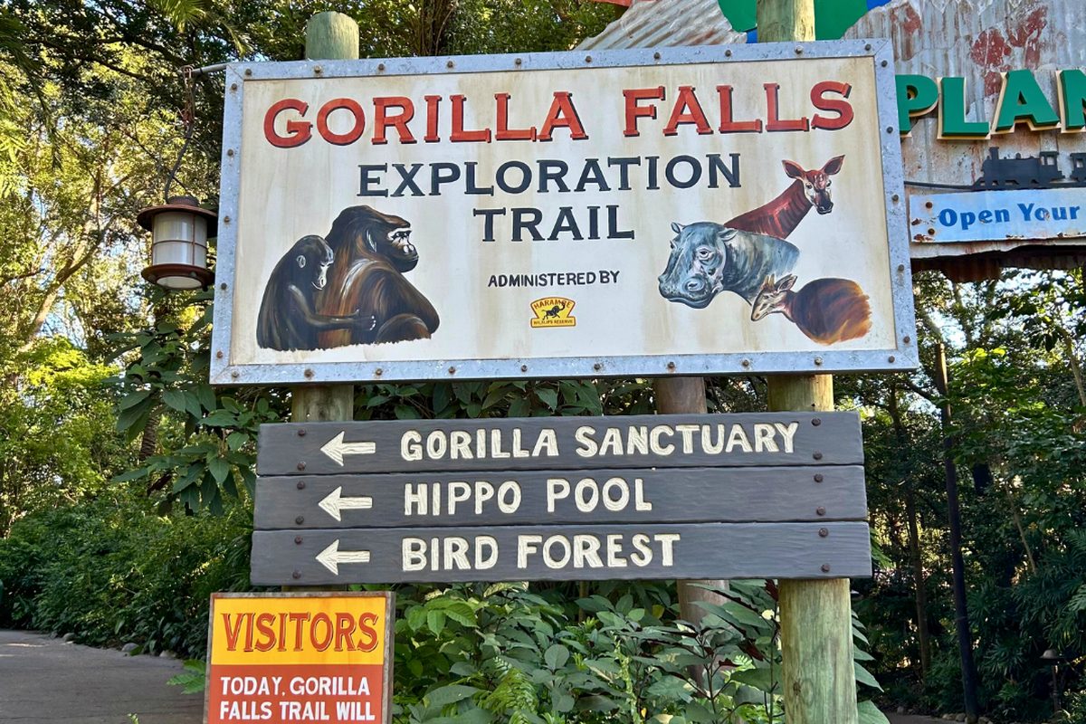 The entrance sign for the Gorilla Falls Exploration Trail in the Africa area of Animal Kingdom, listing the gorilla sanctuary and hippo pool