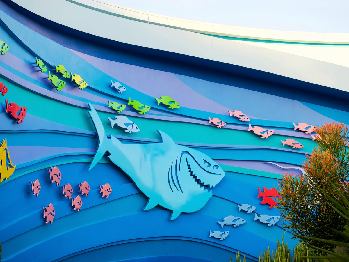 The painted wave mural on the Seas with Nemo & Friends pavilion, with Bruce the shark and shoals of colourful cut-out fish