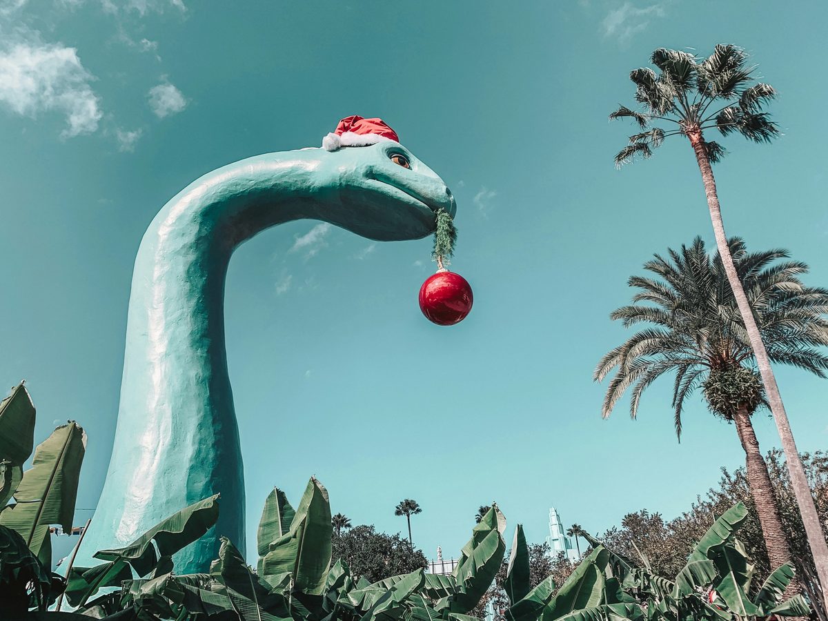 Gertie the dinosaur, the big green dinosaur statue on Echo Lake, wearing a Santa hat