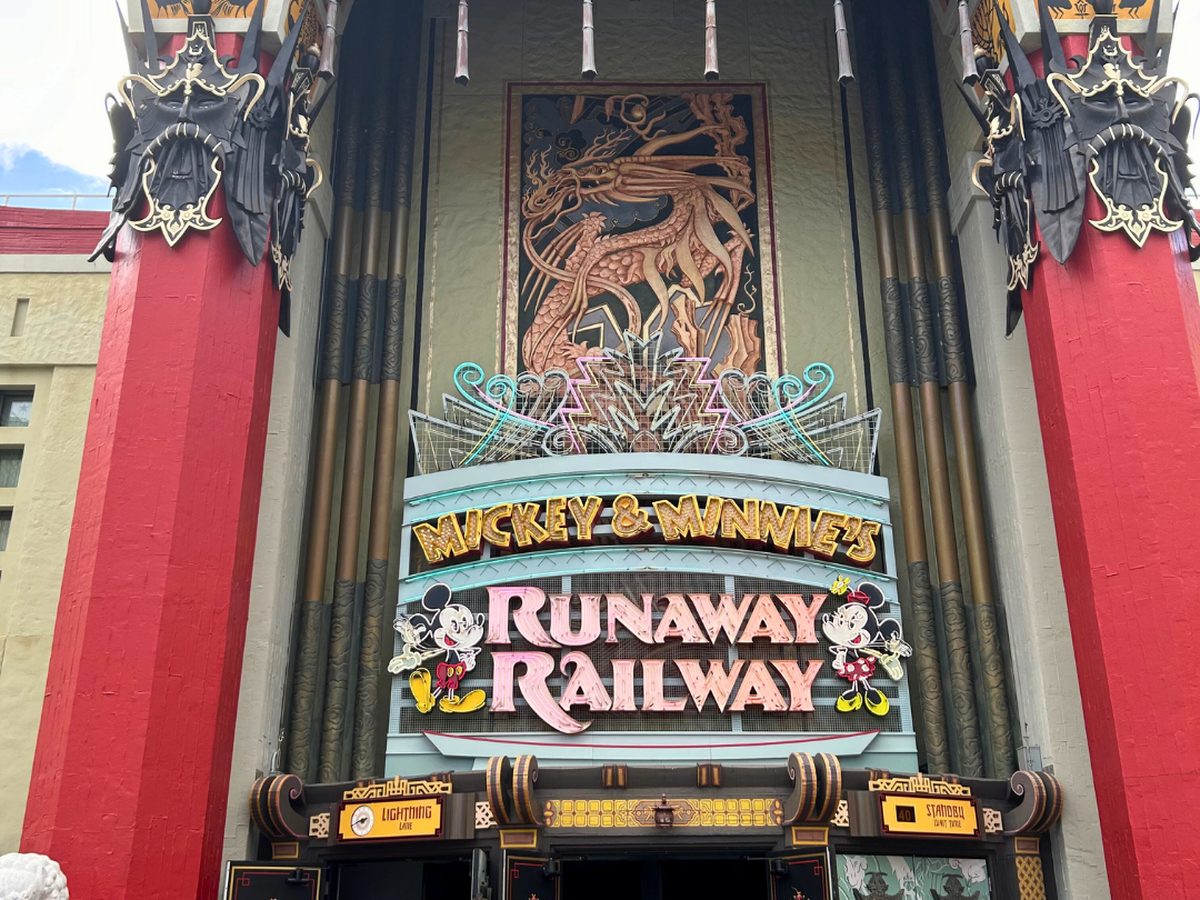 The Mickey & Minnie's Runaway Railway marquee over the Chinese Theatre entrance, with Mickey and Minnie figures either side