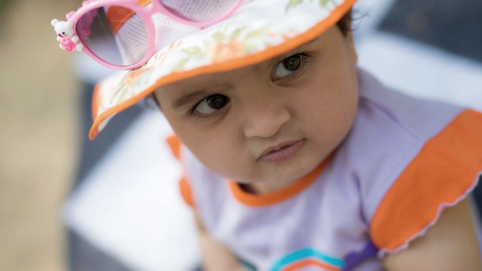 A baby in a wide-brimmed sun hat