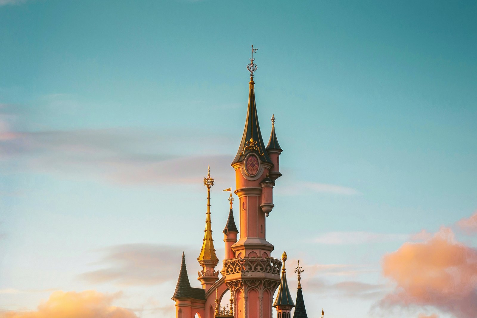 The towers of Sleeping Beauty Castle at Disneyland Paris against an evening sky