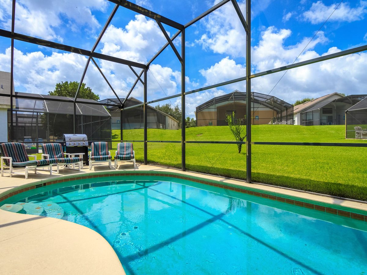 A villa pool inside its screened enclosure, the classic Florida setup