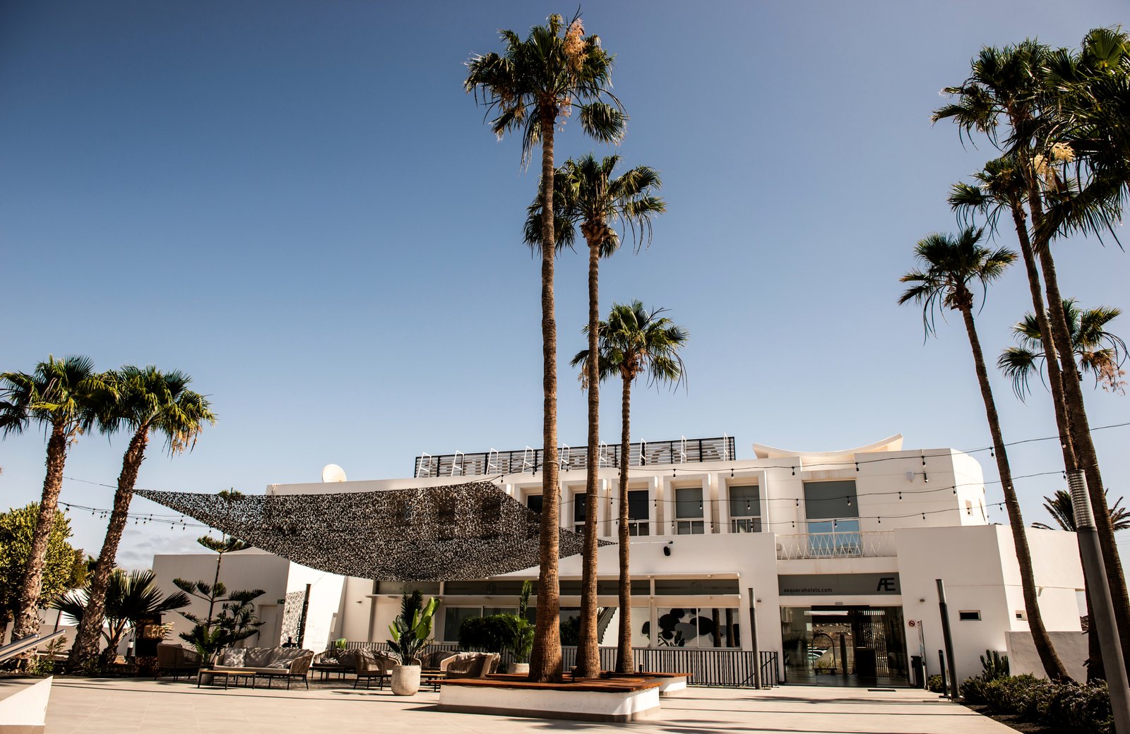 AEQUORA Lanzarote Suites, a low-rise white all-inclusive resort near Playa de los Pocillos in Puerto del Carmen, Lanzarote.