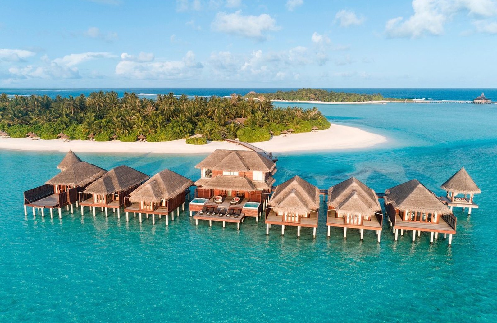 Anantara Dhigu Maldives: villas along a sandy island ringed by a wide, shallow turquoise lagoon in the South Malé Atoll.