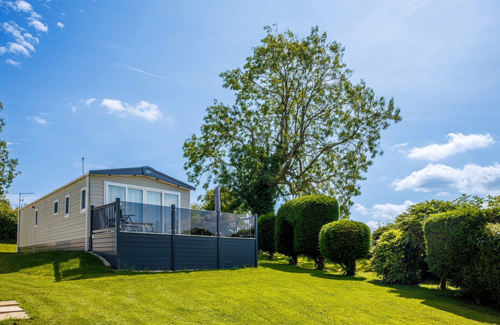 Ashbourne Heights Holiday Park on high ground in the Derbyshire Peak District, with caravans and pitches among the countryside.