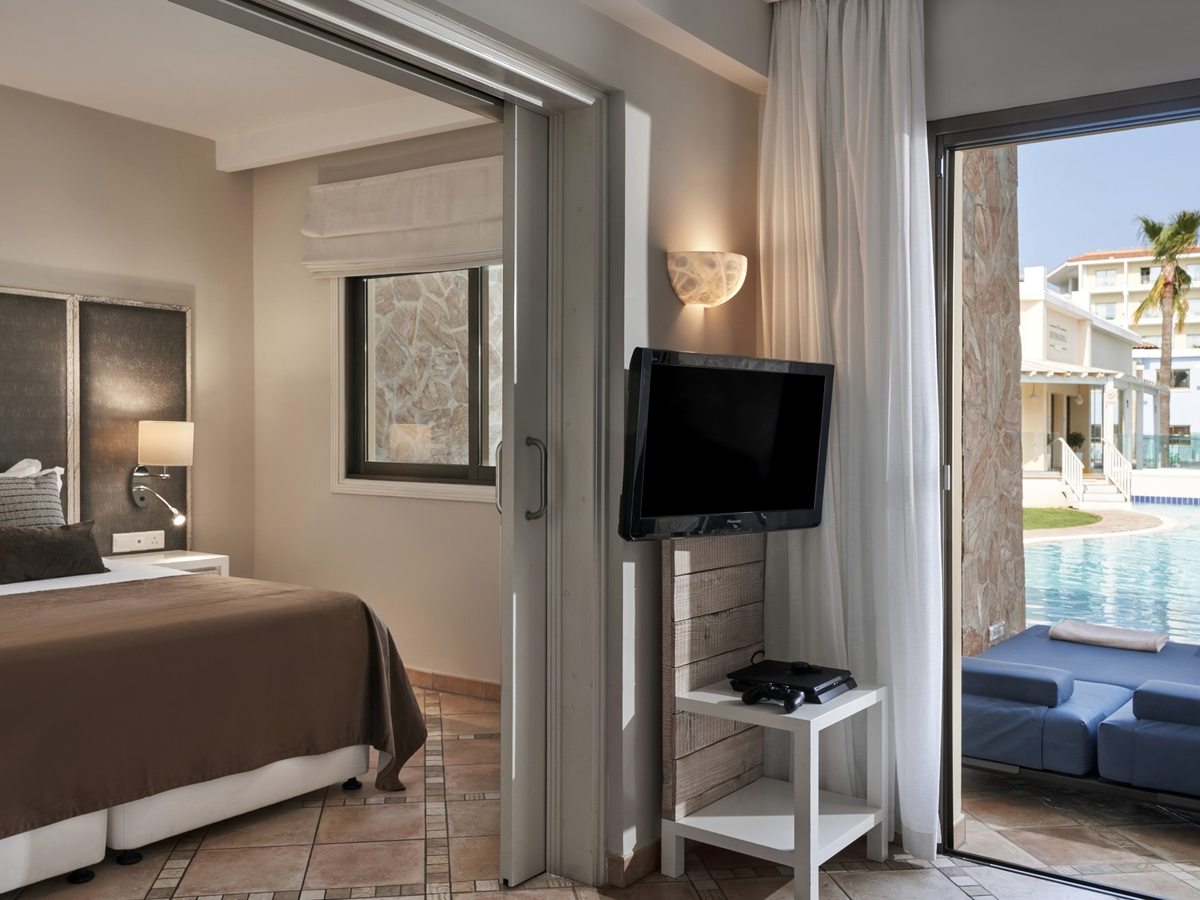 Bedroom with sliding doors through to a terrace and day-bed that open directly onto the main lagoon pool just outside.