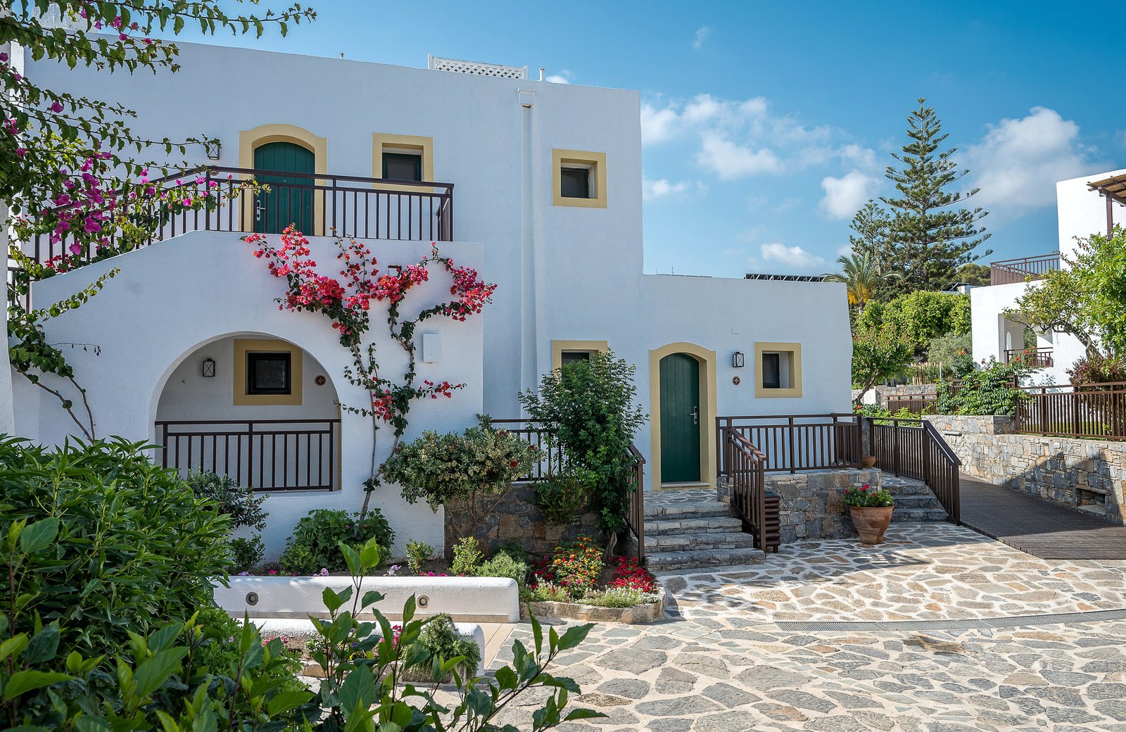 Creta Maris Resort at Hersonissos on the north coast of Crete, a Greek-village layout of whitewashed buildings above its beach and the Aegean.
