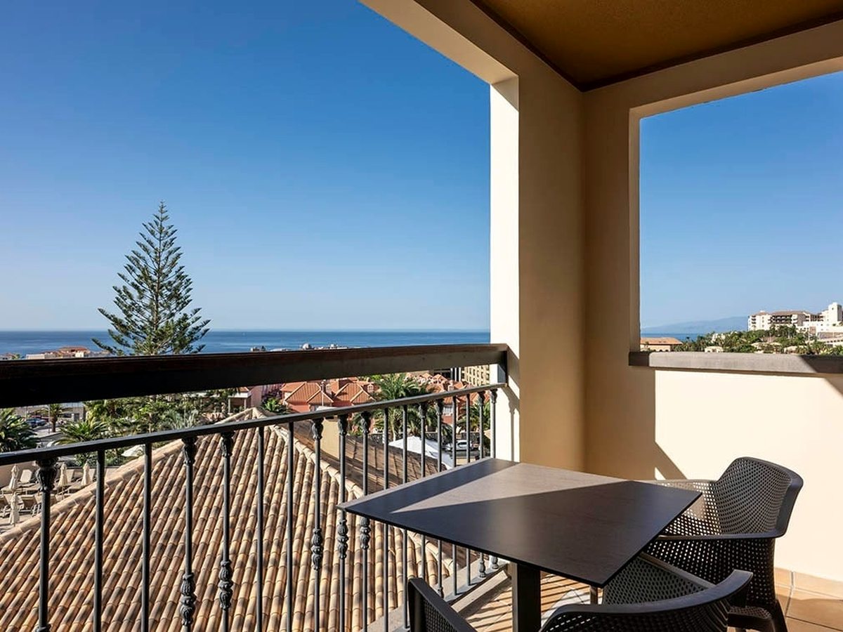 A private balcony with a table and two chairs.