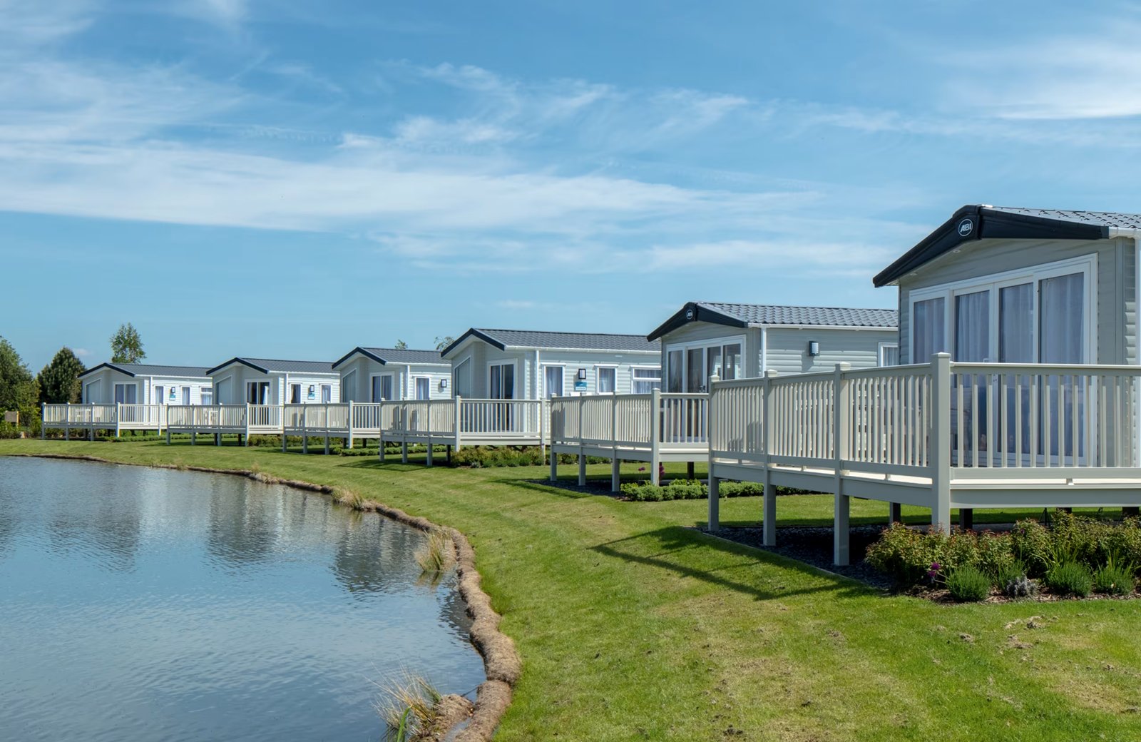 Haven Devon Cliffs: rows of holiday caravans on the green cliffs above Sandy Bay, with the sand and the sea below.