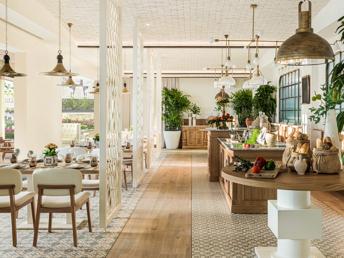 Oliva, the Spanish and Andalusian restaurant at Ikos Andalusia, laid tables under warm timber and terracotta finishes.