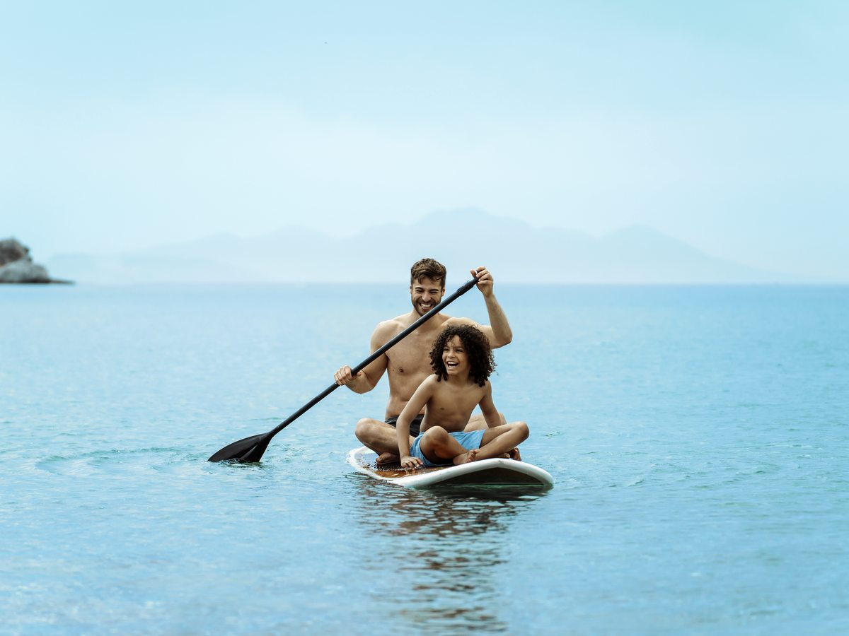 Paddleboarding in the bay at Ikos Aria