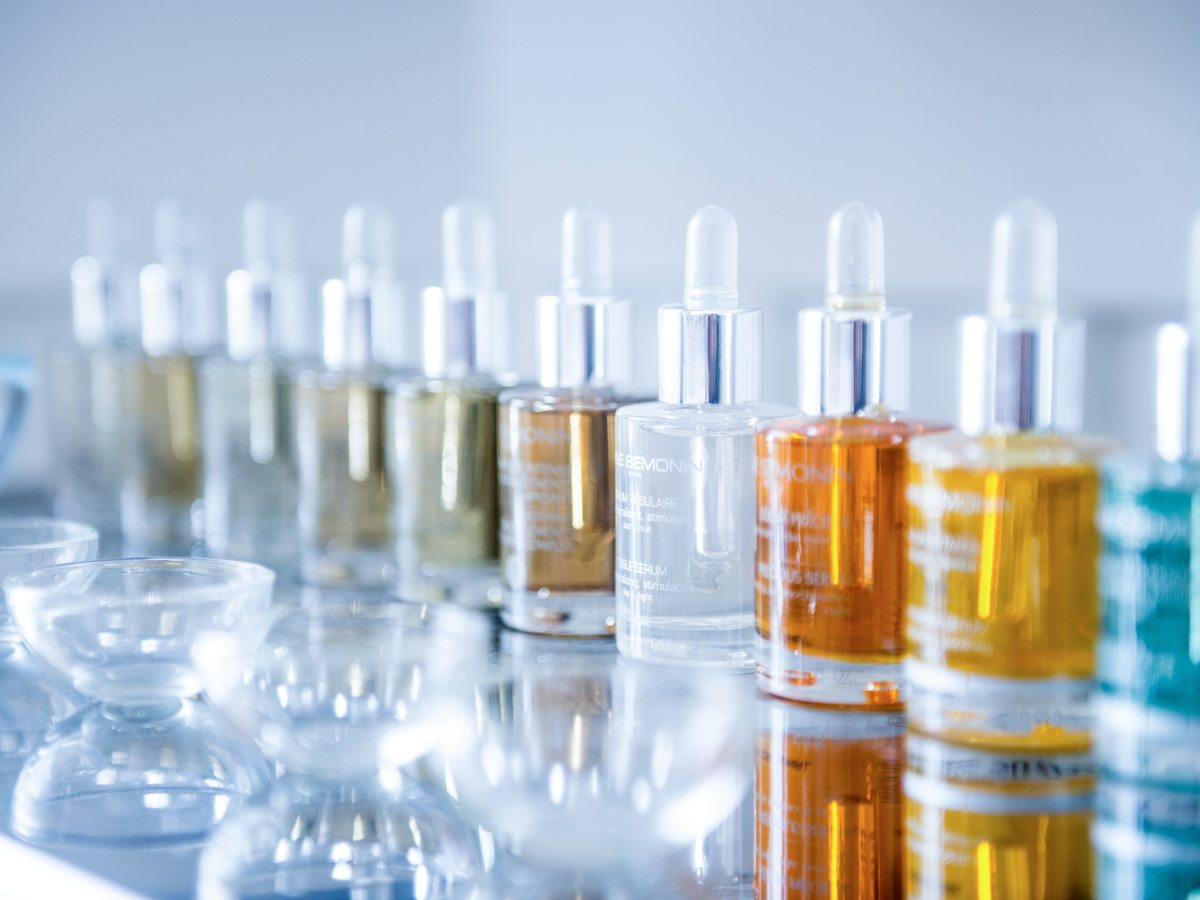 A row of Anne Semonin treatment oils and serums in glass bottles at the Ikos Spa.