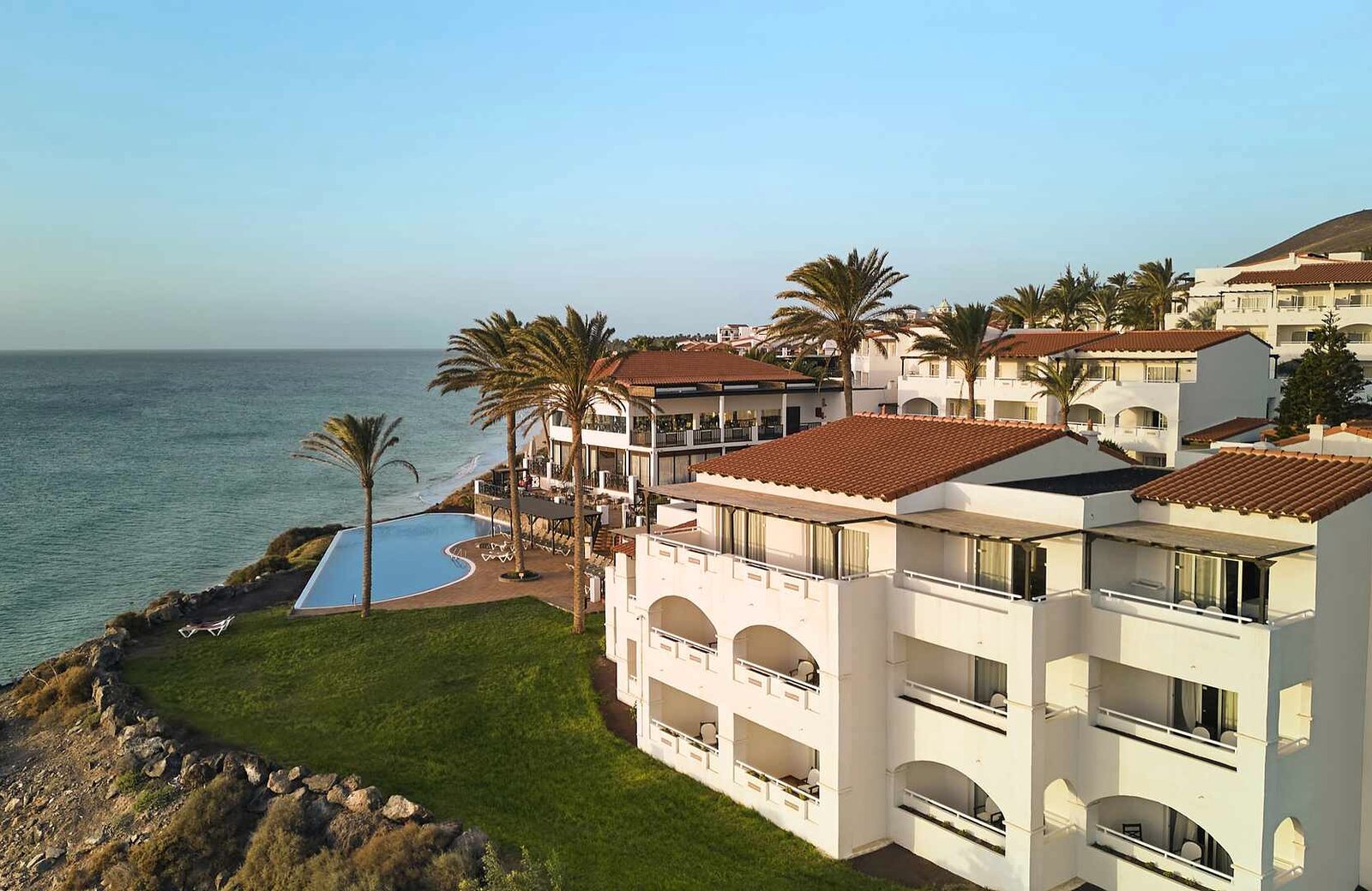 TUI MAGIC LIFE Fuerteventura on the cliffs above Playa de Esquinzo Butihondo, its low-rise blocks stepping down a hillside towards the Atlantic.
