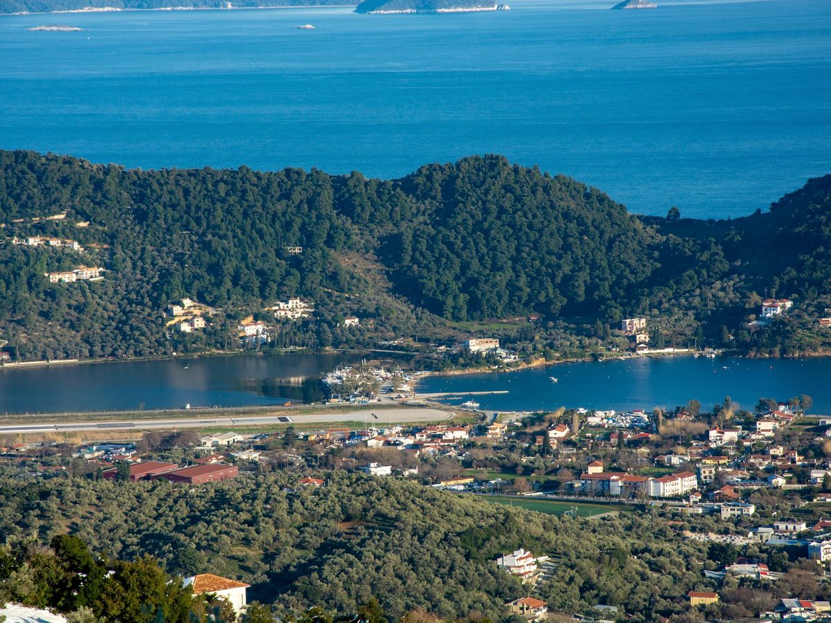 Skiathos Town and its harbour below the green hills
